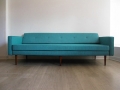 A large 1960s daybed. Solid teak legs. Reupholstered